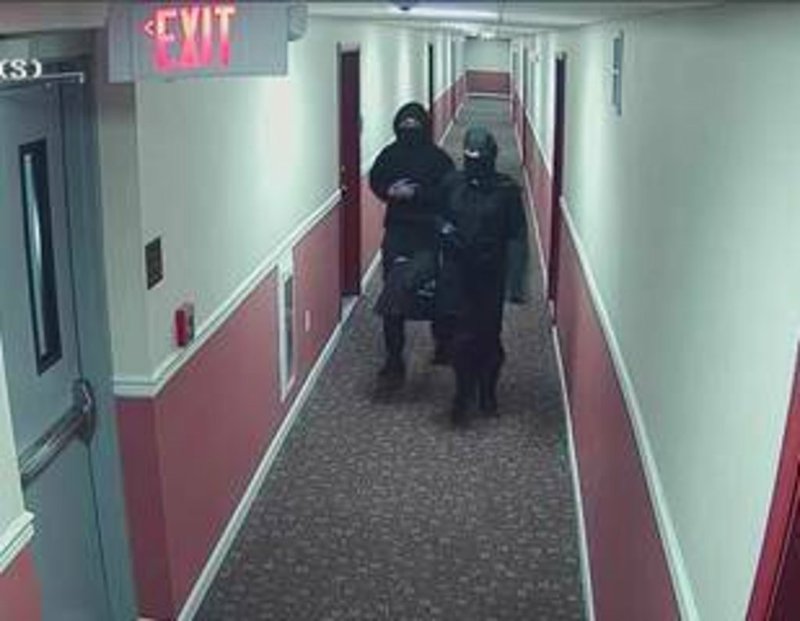 This still image provided by City of Newark Public Safety shows two suspects wanted for arson in an apartment building in Newark, N.J.