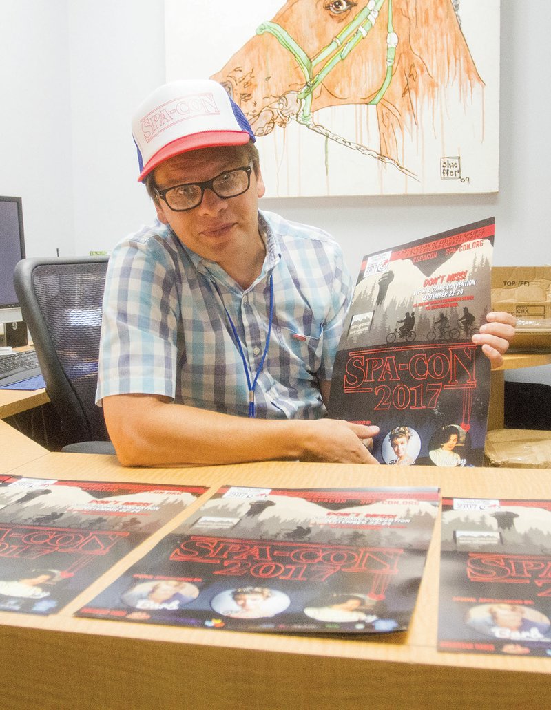 Bill Solleder, the special-events manager for Visit Hot Springs, poses with a poster for this year’s Spa-Con, a comic-book and entertainment convention set for Friday through Sunday at the Hot Springs Convention Center. Tickets are available at www.spa-con.org.