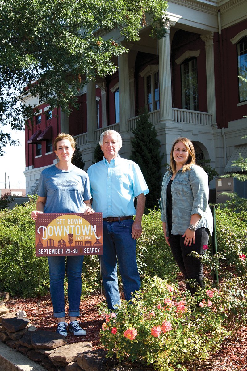 Main Street Searcy board members, from left, Amy Burton, James Carson and Paige Norman prepare for Searcy’s 10th annual Get Down Downtown festival Sept. 29 and 30. The festival will take place in downtown Searcy and feature live music, food, activities for children, vendors and more.