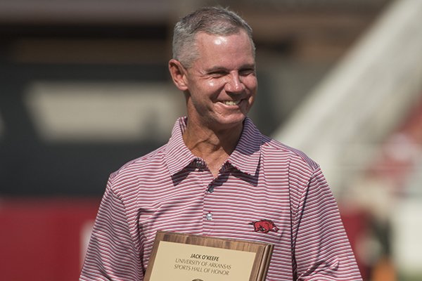 Former Arkansas golfer Jack O'Keefe receives a plaque noting his induction into the UA Sports Hall of Honor during halftime of a football game against TCU on Saturday, Sept. 9, 2017, in Fayetteville. 