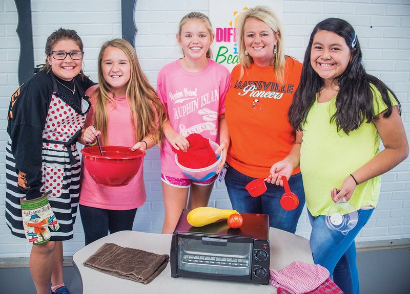 From left, Addie Gillmore, 11, Shaylah Swaim, 12, and Anslee Brewer, 11, stand with their teacher, Lisa Headley, and fellow student Tila Reyes, as they prepare for the upcoming Yum Yum Cooking Club at Central Magnet Elementary School in Batesville. Headley said funds raised by the school’s new Coffee Corner will go toward supplies for the school’s nine-week cooking club, which will likely start in January.