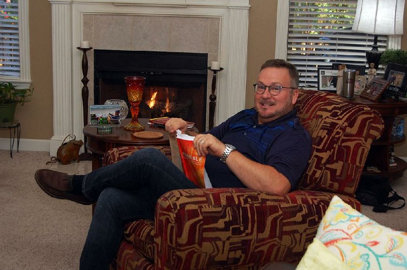 Bryan Stell, development editor for FamilyLife, relaxes in his early-morning Bible study spot the living room of his Maumelle home.