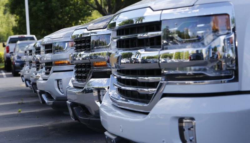 In this Wednesday, April 26, 2017, photo, trucks are lined up in the lot at a dealership in Richmond, Va. Consumers cut back on their shopping in August by the largest amount in six months as a big drop in auto sales offset gains in other areas, according to information released Friday, Sept. 15, 2017, by the Commerce Department. (AP Photo/Steve Helber)