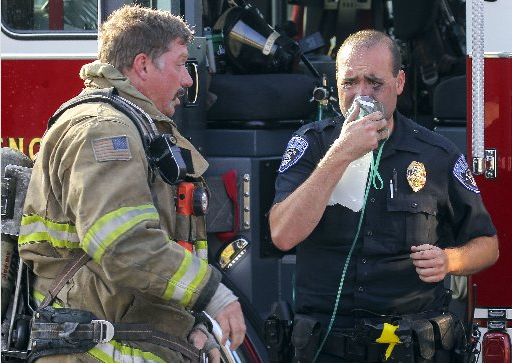 North Little Rock police officer Ryan Osborne is treated for smoke inhalation after trying to save a women trapped in her burning apartment Saturday morning at Eastgate Terrace. The woman did not survive the fire.