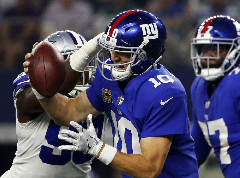 New York Giants quarterback Eli Manning is sacked by DeMarcus Lawrence of the Dallas Cowboys on Monday night. The Giants’ offensive line is one of several that struggled last week.