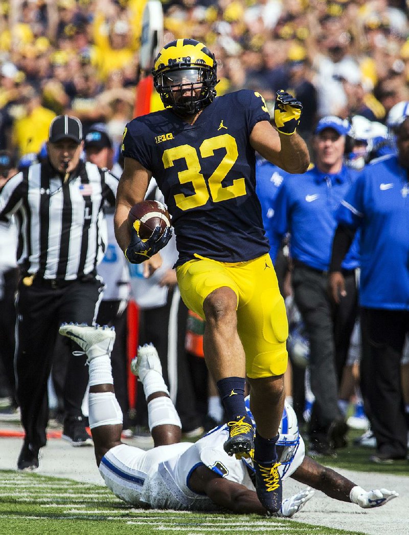 Michigan running back Ty Isaac (32) escapes a tackle by Air Force defensive back Marquis Griffin during the No. 7 Wolverines’ 29-13 victory over the Falcons on Saturday in Ann Arbor, Mich. Isaac led the Wolverines with 89 yards on 16 carries.