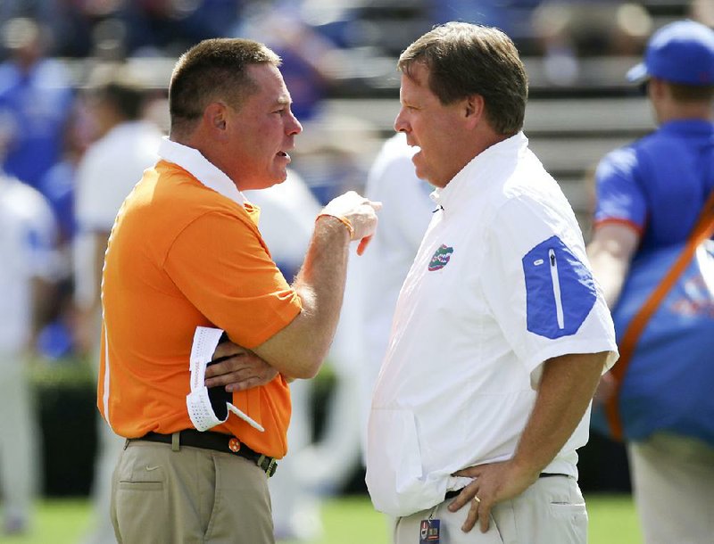 Coach Jim McElwain (right) and the No. 24 Florida Gators could start a season 0-2 for the first time since 1971 if they lose to Butch Jones and the No. 23 Tennessee Volunteers today in Gainesville, Fla. 