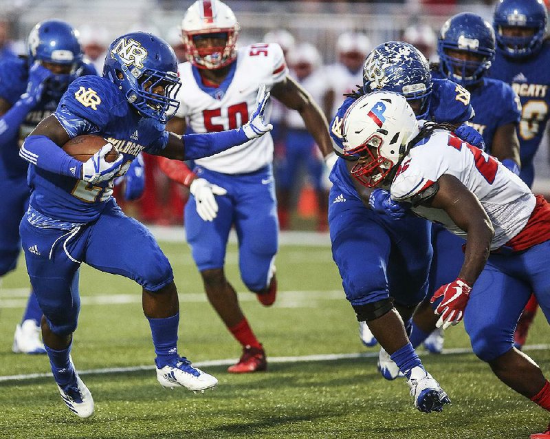 North Little Rock running back Brandon Thomas runs upfield as Little Rock Parkview linebacker Trevon Hadley closes in during Friday night’s game at North Little Rock.