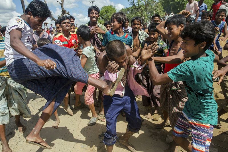 Rohingya Muslims, who recently crossed from Burma into Bangladesh, beat a man suspected of being a child trafficker Friday near a Balukhali refugee camp.