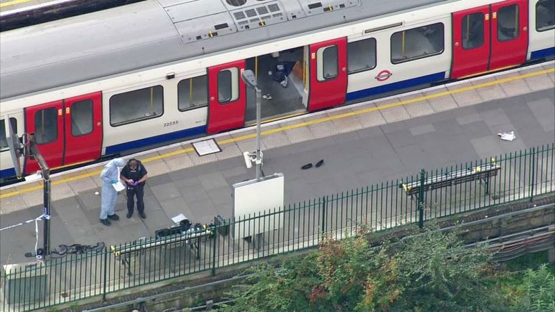 Investigators work Friday at the Parsons Green Underground station in London after a bomb exploded, sending passengers running. One man said it was “like every man for himself to get down the stairs.”