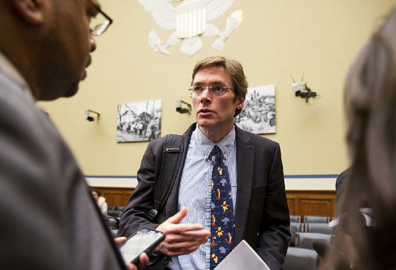 In this March 15, 2016 file photo, Virginia Tech environmental engineering professor Marc Edwards, center, speaks after a Congressional hearing in Washington. 