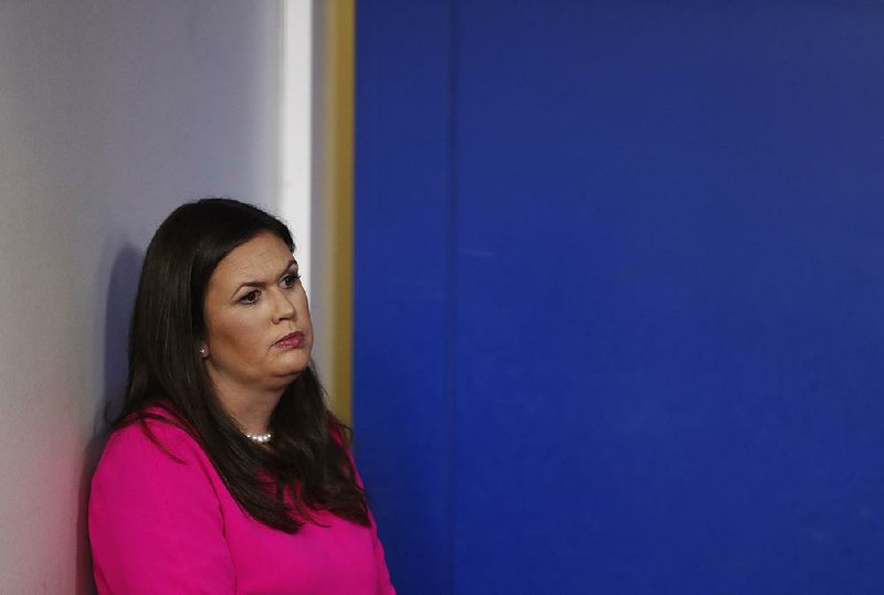 Sarah Huckabee Sanders stands to the side Friday at a White House briefing during which she stuck to her view that it was a “fireable offense” for ESPN anchor Jemele Hill to call Trump a “white supremacist.”