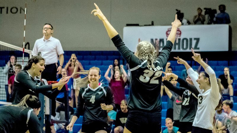 Photo courtesy of JBU Sports Information John Brown University volleyball players celebrate after scoring a point Friday night against Oklahoma City. The Golden Eagles rallied from a 2-0 deficit to come back and beat the Stars in JBU&#8217;s first home game of the season at Bill George Arena.