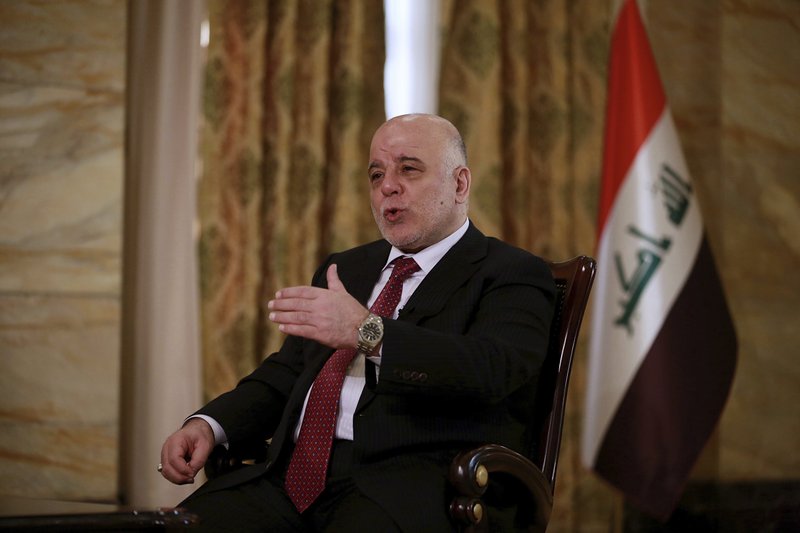 Iraq's Prime Minister Haider al-Abadi speaks during an interview with The Associated Press in Baghdad, Iraq, Saturday, Sept. 16, 2017. Al-Abadi says he is prepared to intervene militarily if the Kurdish region's planned referendum results in violence. (AP Photo/Khalid Mohammed)