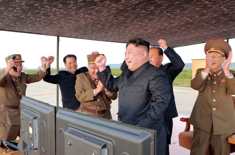 In this undated photo distributed on Saturday, Sept. 16, 2017, by the North Korean government, North Korean leader Kim Jong Un, center, celebrates what was said to be the test launch of an intermediate range Hwasong-12 missile at an undisclosed location in North Korea. Independent journalists were not given access to cover the event depicted in this image distributed by the North Korean government. The content of this image is as provided and cannot be independently verified. (Korean Central News Agency/Korea News Service via AP)