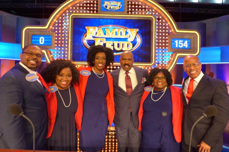 Host of Family Feud Steve Harvey (center) poses with the Chambers family (from left): Fredarick and Erin Wilson, and Erica, Emily and Earl Chambers.

