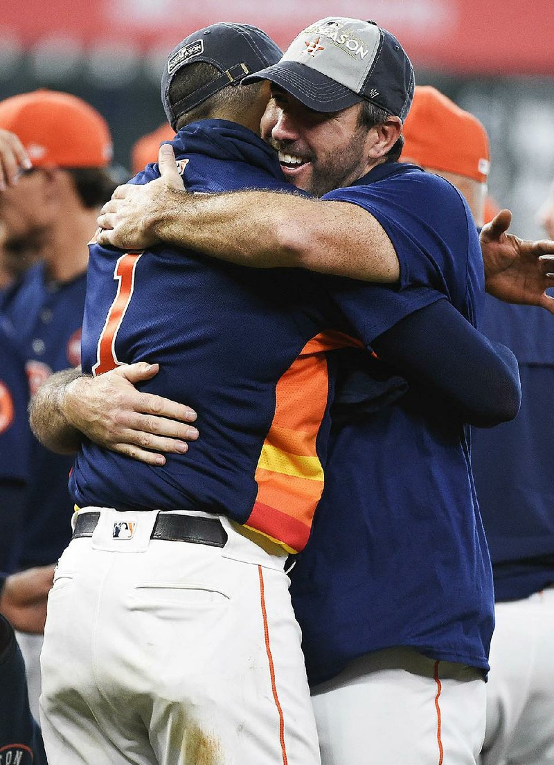 Houston Astros’ Justin Verlander (right) and Carlos Correa celebrate the team’s clinching of the American League West Division championship Sunday in Houston.