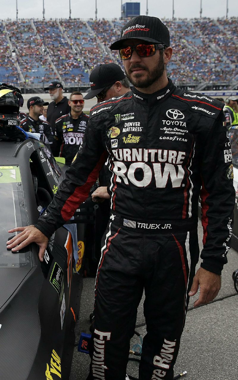 Martin Truex Jr. waits for a NASCAR Cup Monster Energy Series auto race at Chicagoland Speedway in Joliet, Ill., Sunday, Sept. 17, 2017. 
