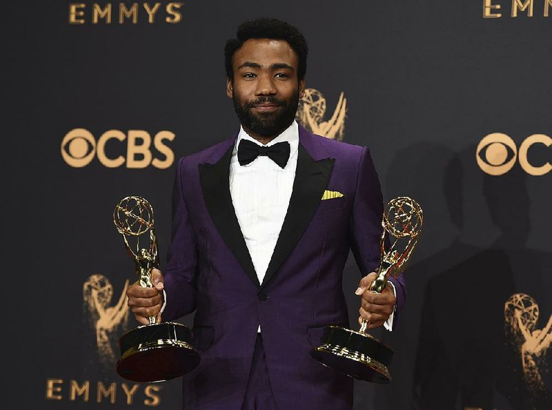 Donald Glover poses in the press room with his awards for outstanding lead actor in a comedy series and for outstanding directing for a comedy series for Atlanta at the 69th Primetime Emmy Awards on Sunday, at the Microsoft Theater in Los Angeles.