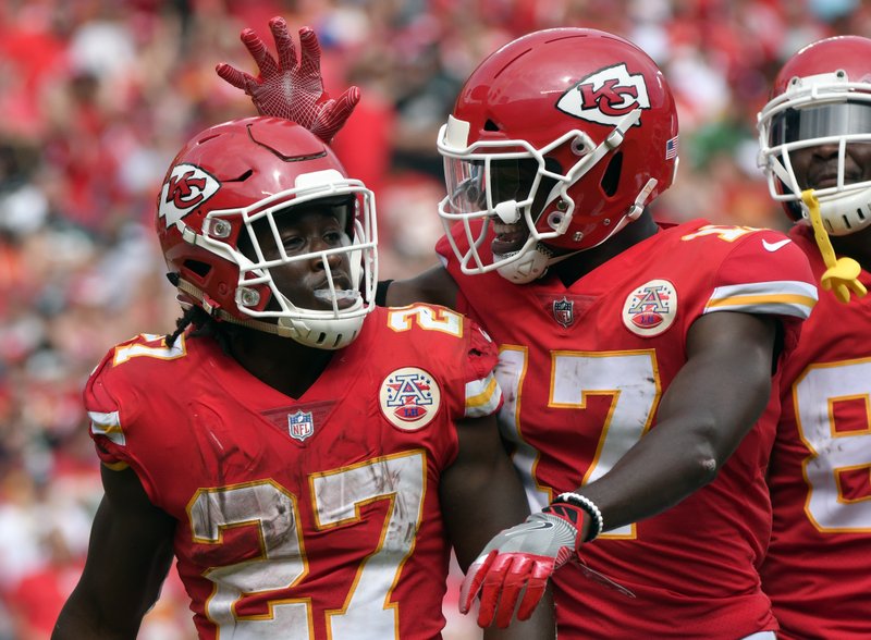 Kansas City Chiefs running back Kareem Hunt (27) is congratulated by wide receiver Chris Conley (17) after scoring a touchdown against the Philadelphia Eagles during the second half of an NFL football game in Kansas City, Mo., Sunday, Sept. 17, 2017. 