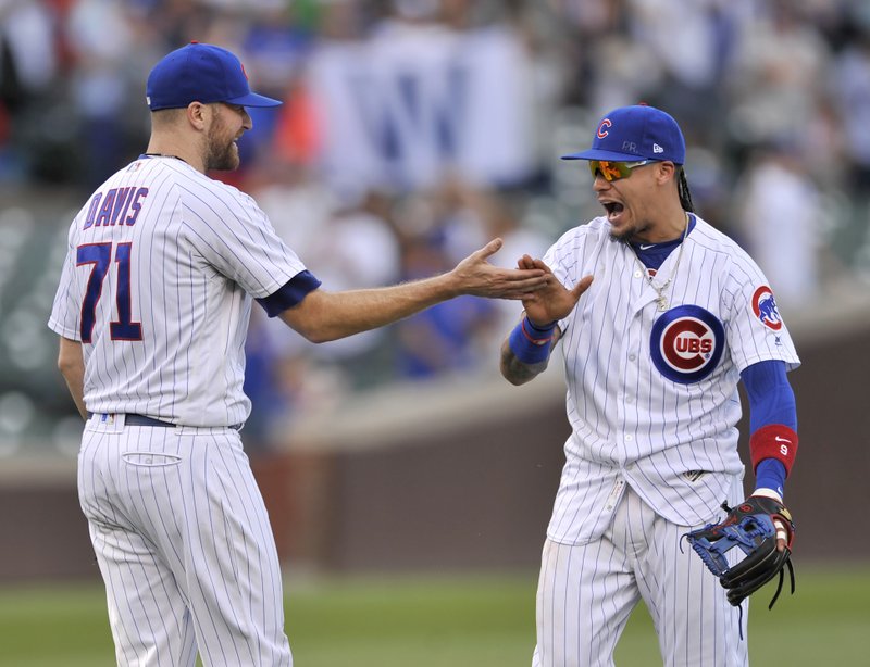Chicago Cubs closing pitcher Wade Davis (71) celebrates with teammate Javier Baez right, after defeating the St. Louis Cardinals in a baseball game Sunday, Sept. 17, 2017, in Chicago. 