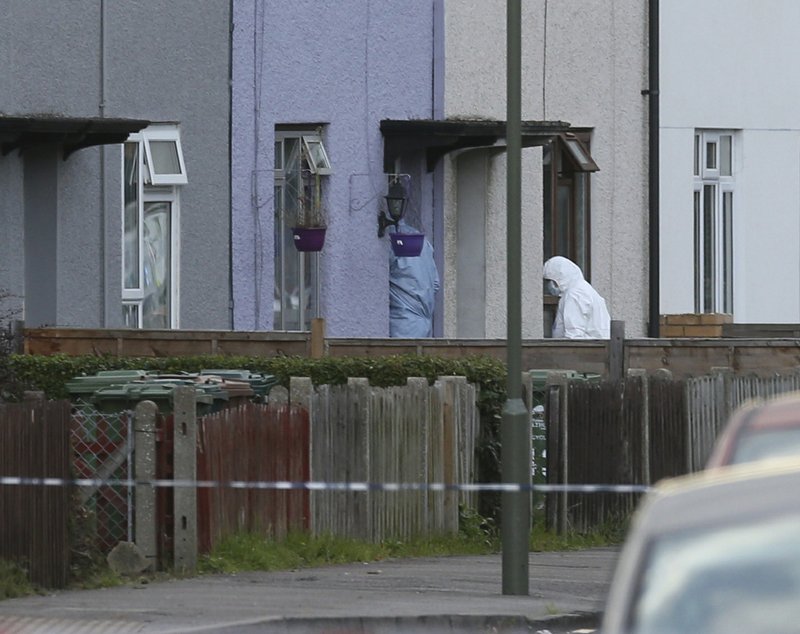 Police forensic officers enter a property in Sunbury-on-Thames, southwest London, as part of the investigation into Friday's Parsons Green bombing, Saturday Sept, 16, 2017. 