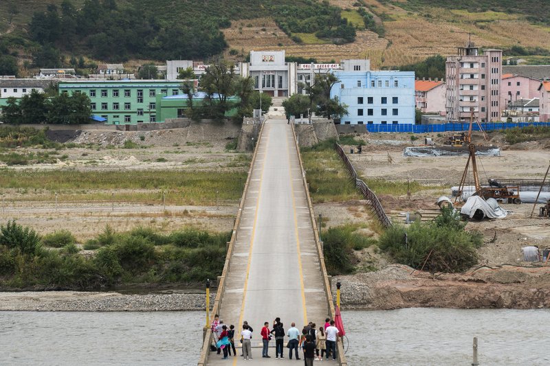 In this Sunday, Sept. 10, 2017, photo, Chinese tourists stand watch on Tumen bridge linking China and North Korea, as seen from Yanbian, Jilin province. U.S. Secretary of State Rex Tillerson on Friday, Sept. 15, 2017, calling on all nations to take new measures against Kim Jong Un's regime after North Korea's latest missile launch. 