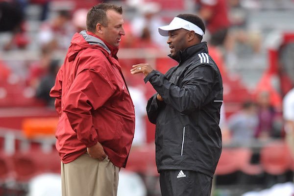 Arkansas coach Brett Bielema talks with Texas A&M coach Kevin Sumlin before the start of the teams' 2013 matchup at Razorback Stadium in Fayetteville.