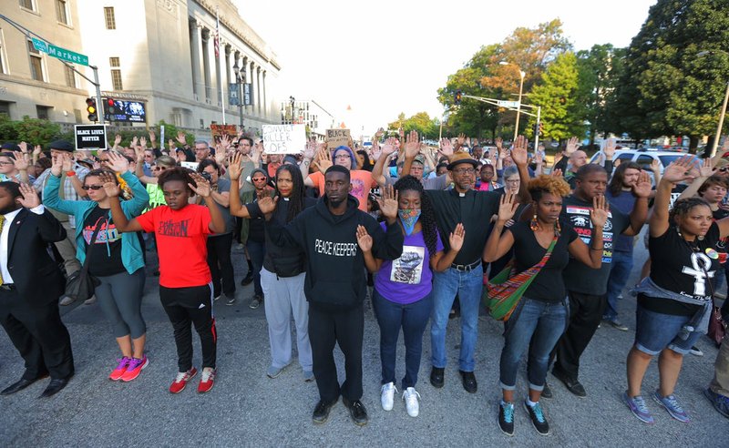 Protesters march in silence down Market Street in St. Louis on Monday, Sept. 18, 2017, in response to a not guilty verdict in the trial of former St. Louis police officer Jason Stockley.