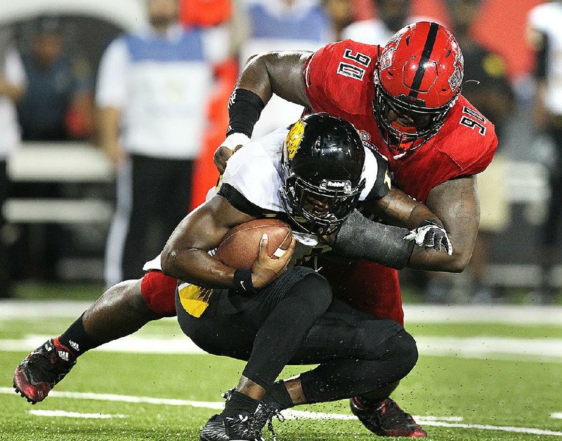 Arkansas State defensive lineman Josh Curry (90) tackles UAPB  quarterback LaEarl Patterson during the fourth quarter of the Red Wolves’ 48-3 victory on Saturday in Jonesboro.