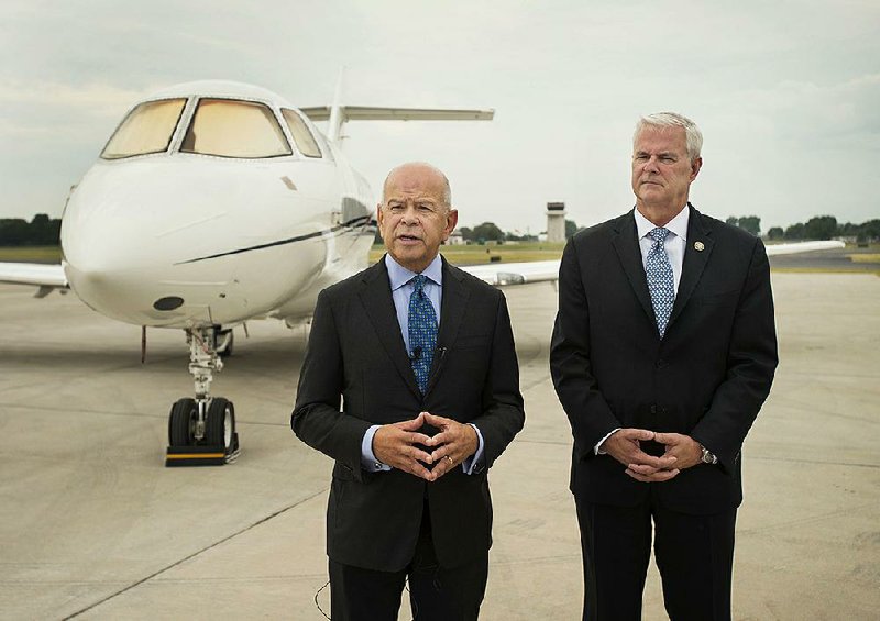 Michael Huerta (left), director of the Federal Aviation Administration, toured the Northwest Arkansas Regional Airport on Monday at the invitation of Rep. Steve Womack, R-Ark., (right) of Rogers.