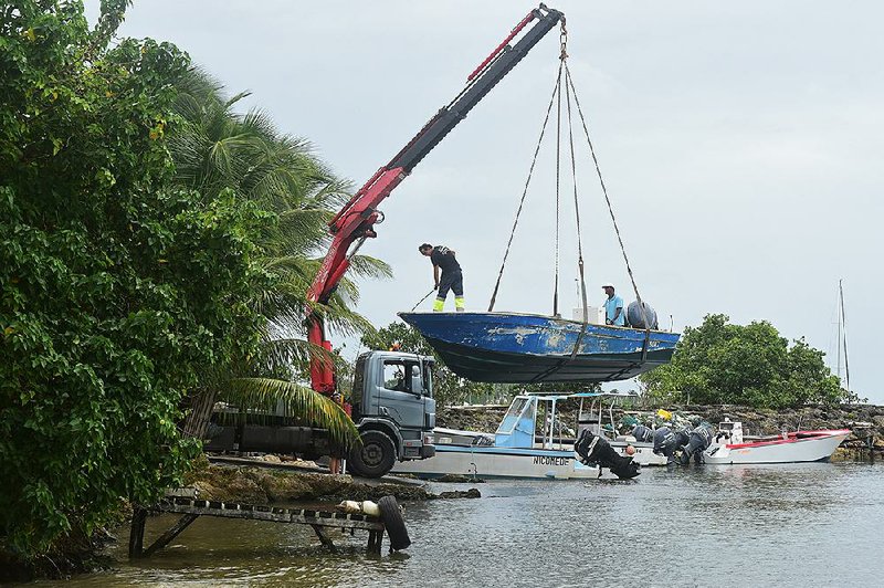 Men remove boats from the water ahead of Hurricane Maria in the Galbas area of Sainte-Anne on the French Caribbean island of Guadeloupe early Monday.