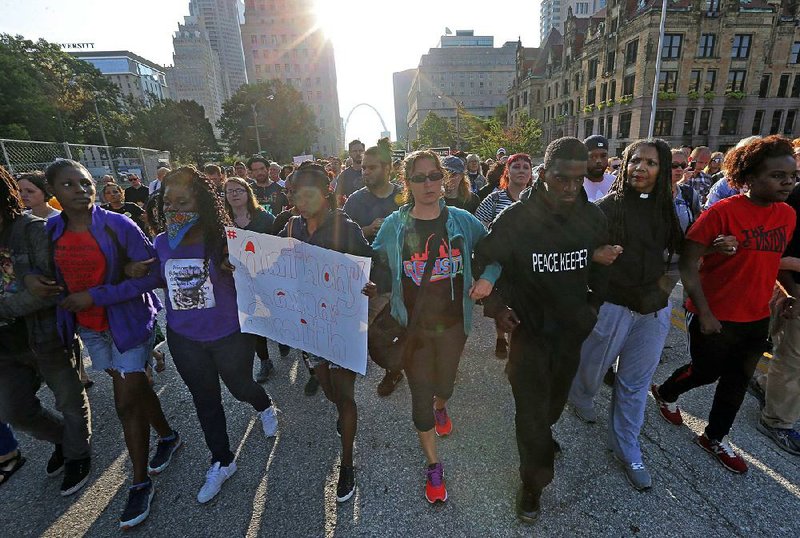 State Rep. Bruce Franks Jr. (third from right) leads a silent march Monday on Market Street in St. Louis.