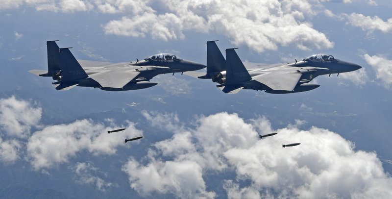 In this photo provided by South Korea Defense Ministry, South Korean F-15K fighter jets drop bombs as they fly over the Korean Peninsula during a joint drills with the U.S., South Korea on Monday, Sept. 18, 2017. South Korea says the U.S. military has flown powerful bombers and stealth jets over the Korean Peninsula in joint drills with South Korean warplanes. (South Korea Defense Ministry via AP)