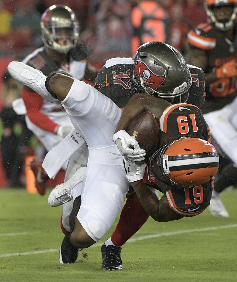 In this Aug. 26, 2017, file photo, Cleveland Browns wide receiver Corey Coleman (19) is taken down by Tampa Bay Buccaneers strong safety Keith Tandy (37) during the first quarter of an NFL preseason football game, in Tampa, Fla. 