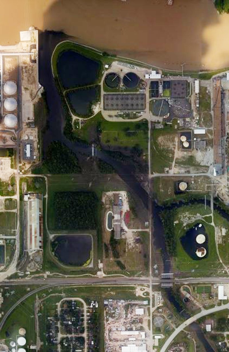 This handout aerial photo from the National Oceanic and Atmospheric Administration shows floodwaters surrounding the U.S. Oil Recovery Superfund site outside Houston flowing into the San Jacinto River.