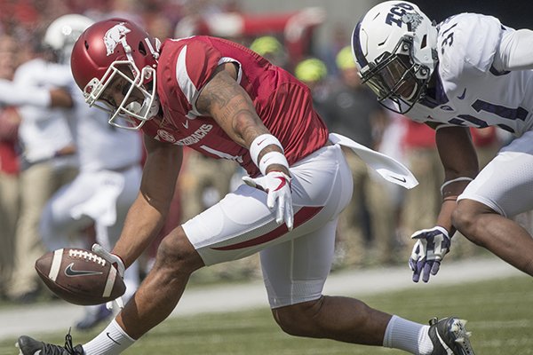 Arkansas receiver Jared Cornelius drops a pass in front of TCU's Ridwan Issahaku during a game Saturday, Sept. 9, 2017, in Fayetteville. 