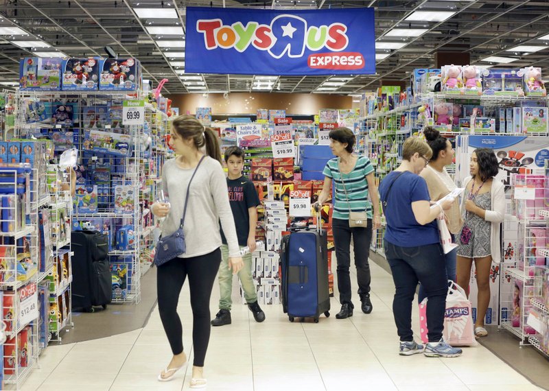 FILE - In this Friday, Nov. 25, 2016, file photo, shoppers shop in a Toys R Us store on Black Friday in Miami. Toys R Us, the pioneering big box toy retailer, announced late Monday, Sept. 18, 2017 it has filed for Chapter 11 bankruptcy protection while continuing with normal business operations. (AP Photo/Alan Diaz, File)
