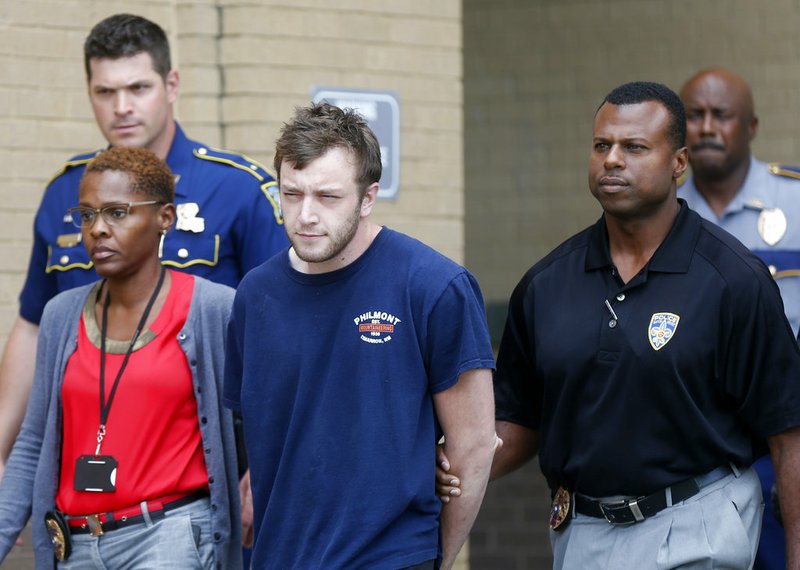 Kenneth James Gleason is escorted by police to a waiting police car in Baton Rouge, La., on Tuesday, Sept. 19, 2017.