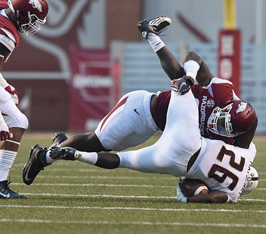 NWA Democrat-Gazette/Michael Woods ‘BACKER TO WORK: Linebacker Dre Greenlaw, here bringing down a Texas State runner in a 2016 game in Fayetteville, adjusts to his new role in Arkansas’ 3-4 defensive front. Greenlaw comes off a 17-tackle effort in the 28-7 loss to TCU Sept. 9 that dropped the Razorbacks to 1-1 before their Southeastern Conference opener Satuday against Texas A&M. Kickoff is 11 a.m. at AT&T Cowboys Stadium in Arlington, Texas.