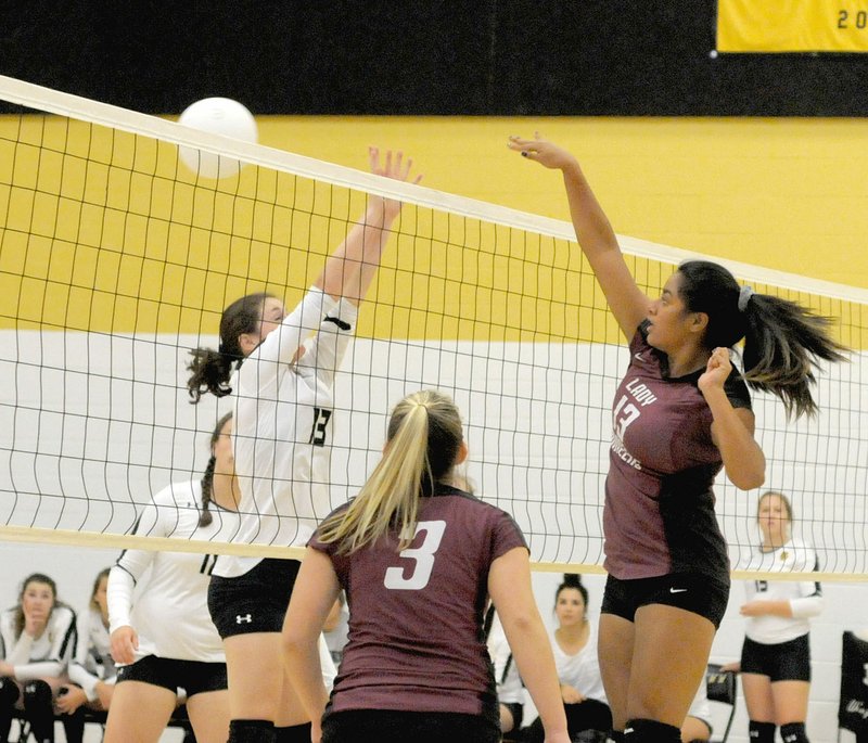 Photo by Mark Humphrey Gentry senior Chastery Fuamatu goes for a kill against Prairie Grove while teammate Madison Stanfill watches in case of a block. The Lady Tigers swept the Lady Pioneers three games to none (25-18, 27-25, 25-11) Tuesday, Sept. 12, in 4A-1 volleyball action.