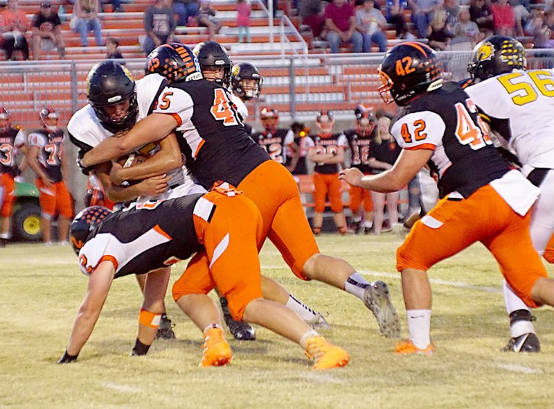 Photo by Randy Moll Bailey Soule&#8217; (No. 45) and Gunner Berger (No. 2) drag down Gabe Simpson, Jay&#8217;s quarterback, while Colton Grimes (No. 42) closes in during play in Lion Stadium at Gravette on Friday night.