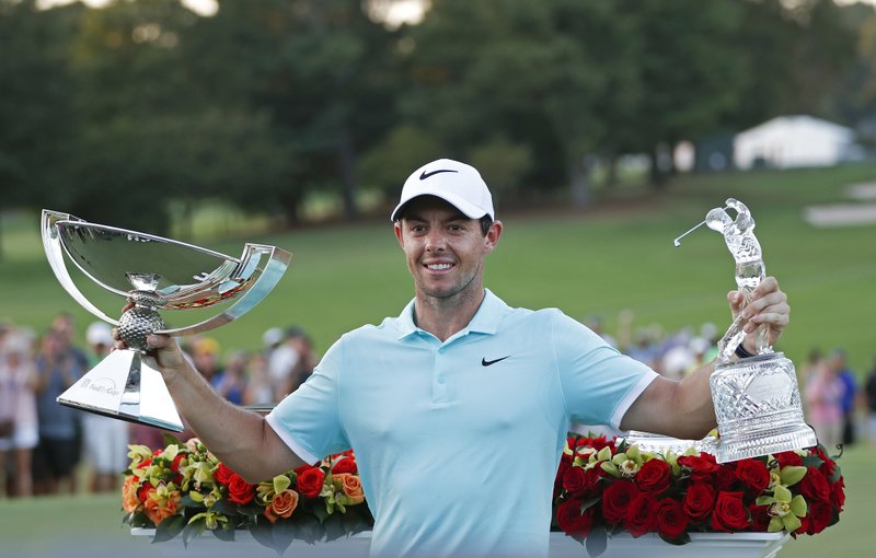 The Associated Press SWEEPS WEEK: Rory McIlroy poses with the trophies after winning the Tour Championship golf tournament the FedEx Cup last year. The 2016-2017 PGA Tour ends with the Tour Championship Thursday through Sunday at East Lake Golf Club in Atlanta.