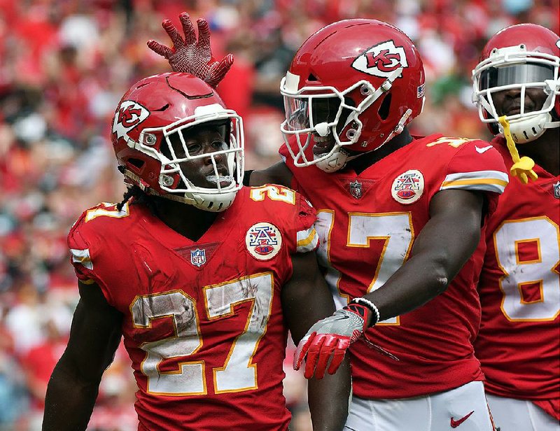 Kansas City Chiefs rookie running back Kareem Hunt (27) is congratulated after scoring a touchdown Sunday against the Philadelphia Eagles. His five touchdowns are the most by an NFL rookie through two games since 1920.