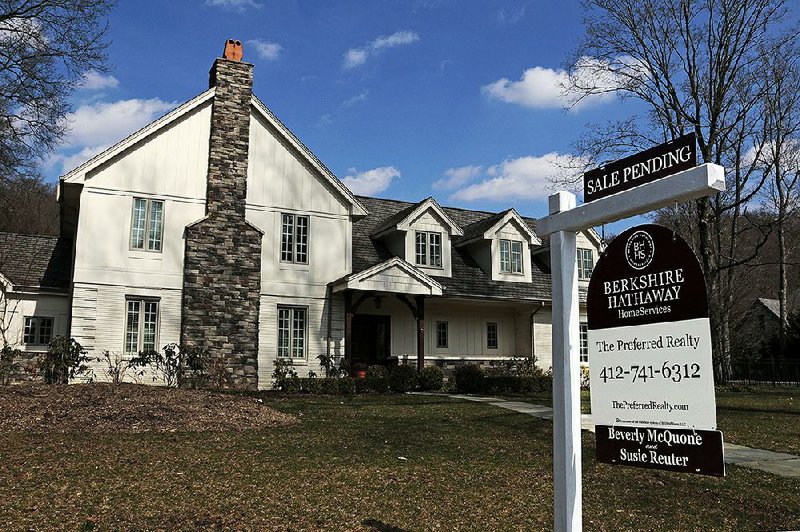 This March photo shows a house for sale in Sewickley, Pa. The National Association of Realtors said Wednesday that sales of previously owned homes sank last month to a seasonally adjusted annual rate of 5.35 million.