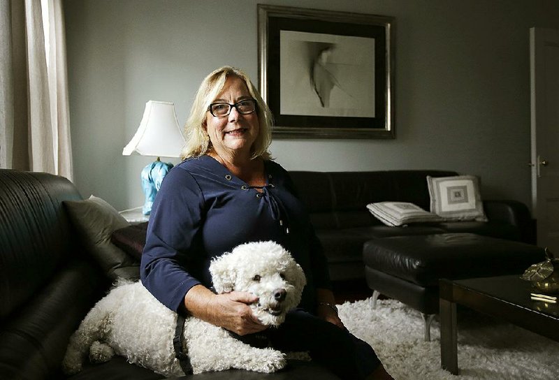 Airbnb operator Jennifer McConnell sits with her dog Skipper in her home in Cambridge, Mass., earlier this month. The Cambridge City Council last month approved regulations requiring people offering shortterm rentals to live in the same building and undergo an inspection once every five years. 
