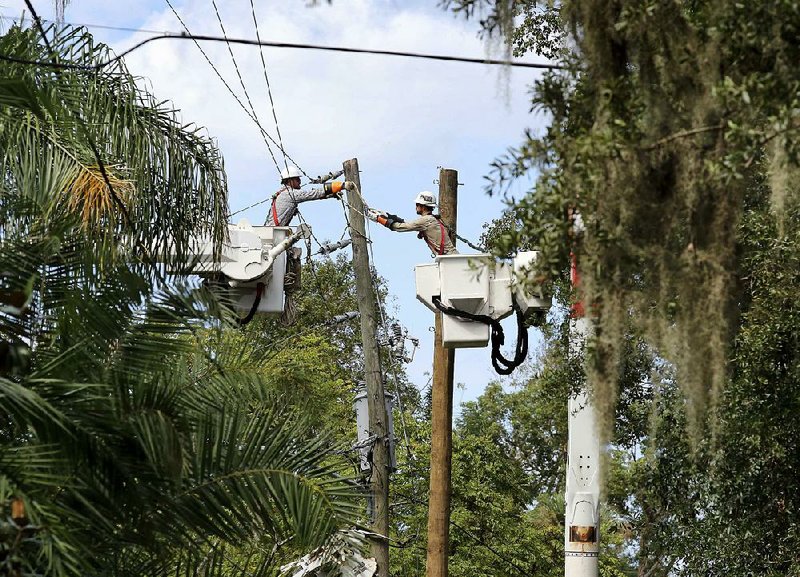 Linemen from Duke Energy work to replace a utility pole Tuesday in Maitland, Fla. 