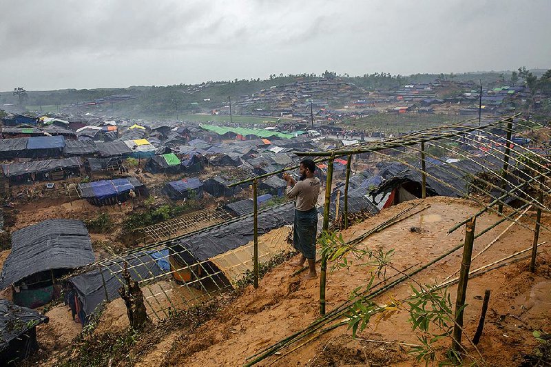 A Rohingya Muslim man who crossed over from Burma into Bangladesh builds a shelter for his family in Taiy Khali refugee camp Wednesday. 