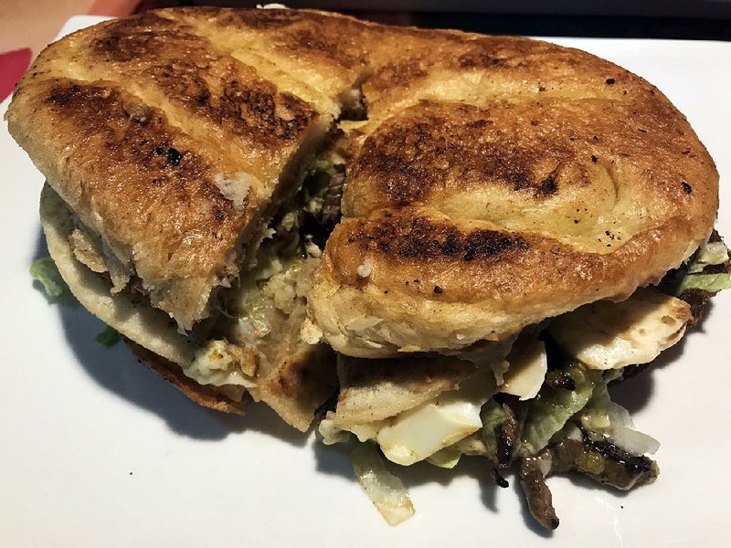 The Guajolote at Chano’s Mexican Grill in Little Rock is a sandwich stuffed with meat, boiled egg, green enchiladas and beans. 