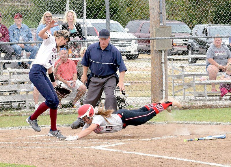 Photo by Rick Peck McDonald County&#8217;s Whitney Kinser dives headfirst into home plate for a run during the Lady Mustangs&#8217; 9-3 win over Joplin on Sept. 12 at MCHS.
